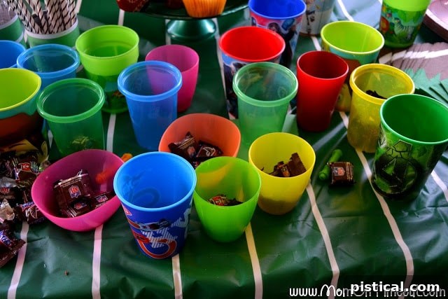Kids sorting Snickers NFL minis into different cups by team