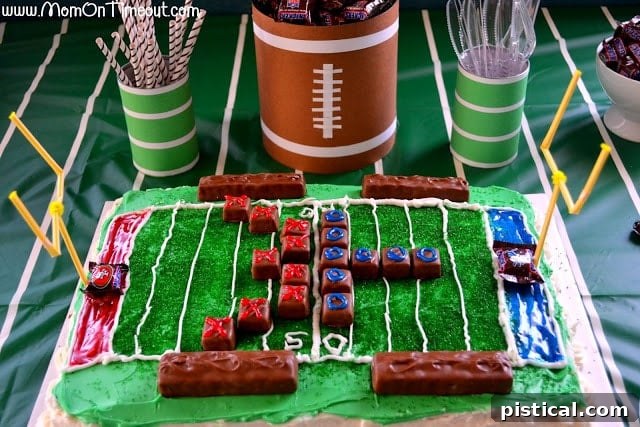 Table centerpiece: Football field cake surrounded by Snickers mini containers