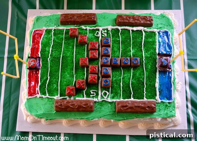 Aerial view of the football field cake with Snickers players and snacks