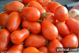 Selection of fresh, ripe Roma tomatoes, ideal for making a thick, flavorful pasta sauce.