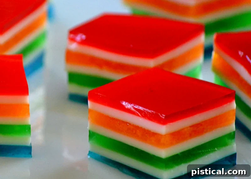 Vibrant rainbow jello cubes, perfect for a party