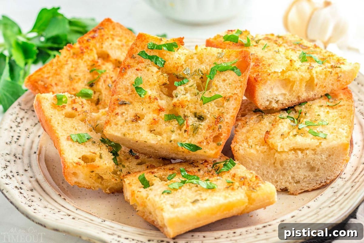 A wide shot of golden Air Fryer Garlic Bread slices arranged on a white plate, elegantly garnished with fresh parsley and ready to serve.