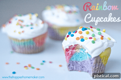 Festive Rainbow Cupcakes from The Happier Homemaker with swirled colorful frosting, easy to make.