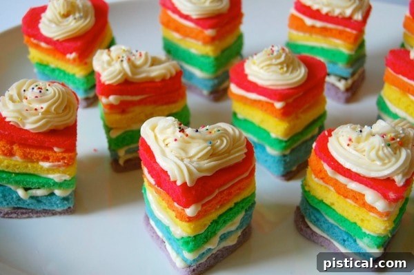 Adorable Rainbow Heart Cakes, individual mini cakes with colorful layers, perfect for sharing love.