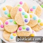 A delicious Easter Cake Mix Cookie, dipped in white chocolate and decorated with M&M's.