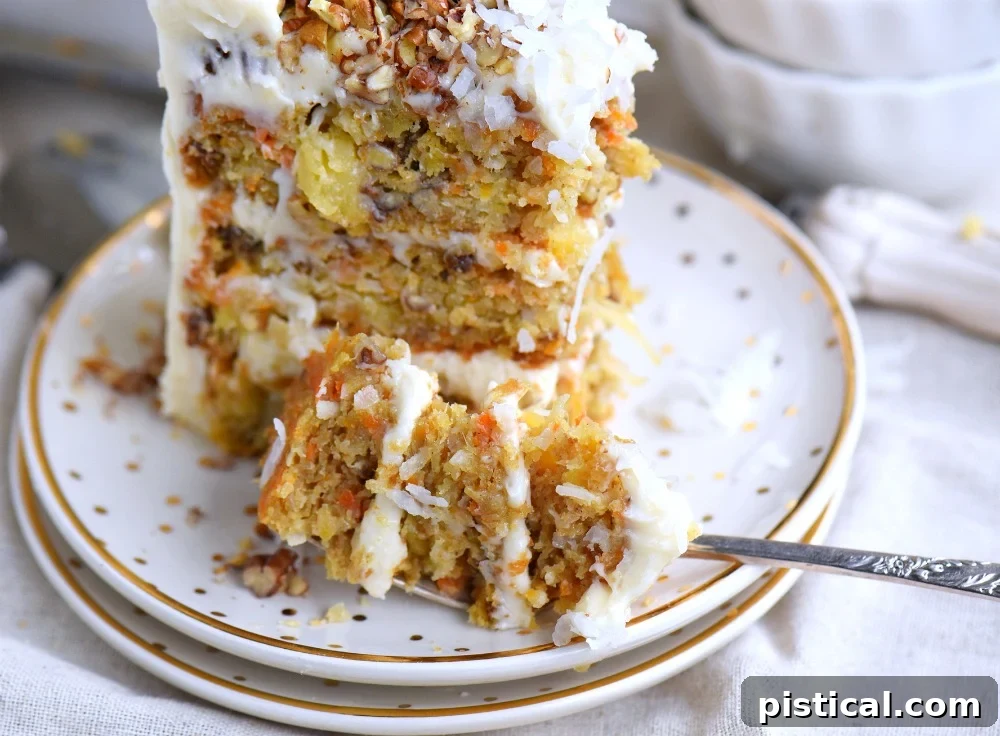 A slice of the best carrot cake with thick cream cheese frosting