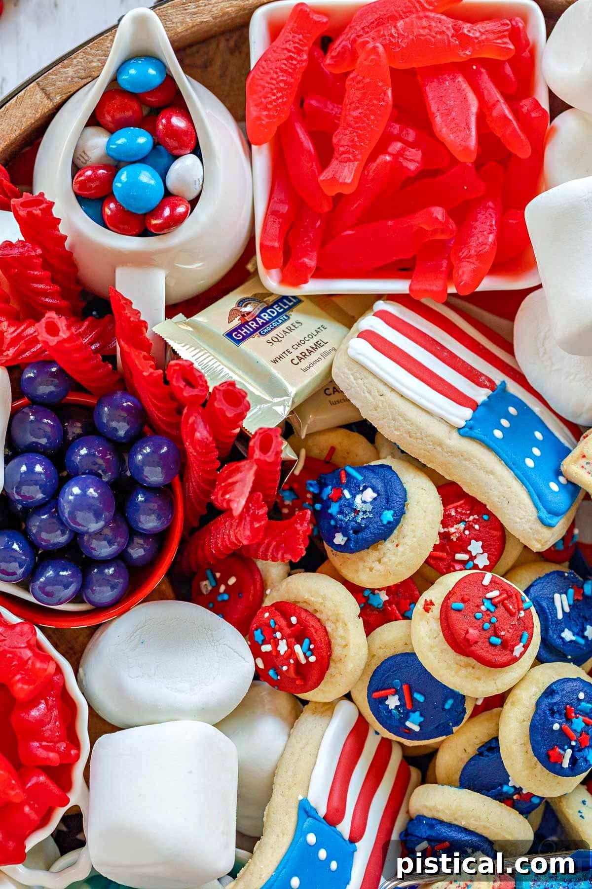 Red, White & Blue Grazing Board 5 close up top down view of 4th of july cookies and treats on a large round board.