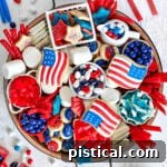 Red, White & Blue Grazing Board 9 top down look at wood charcuterie board loaded with red white and blue desserts for 4th of july. cookies, candy and all sorts of colorful treats.