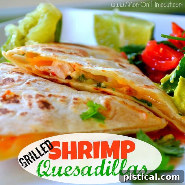 Two halves of a grilled shrimp quesadilla on a wooden serving board, garnished with cilantro and lime wedges