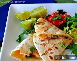 Assortment of fresh ingredients including limes, cheese, and cilantro, ready for quesadilla preparation