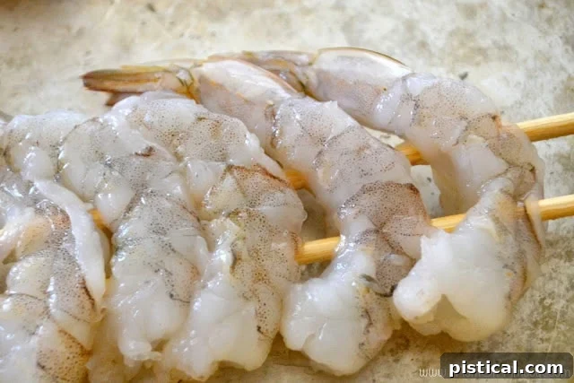 Shrimp perfectly arranged on double skewers, ready for marination