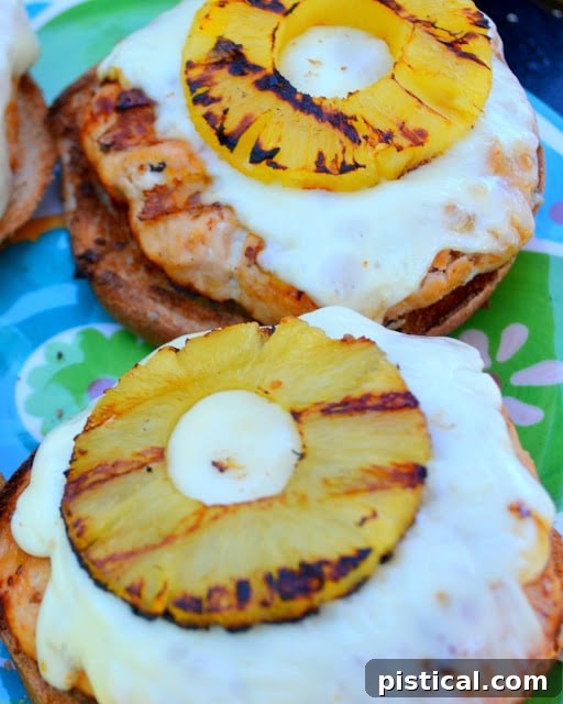 Assembled Teriyaki Pineapple Turkey Burger on a bun with cheese and grilled pineapple.