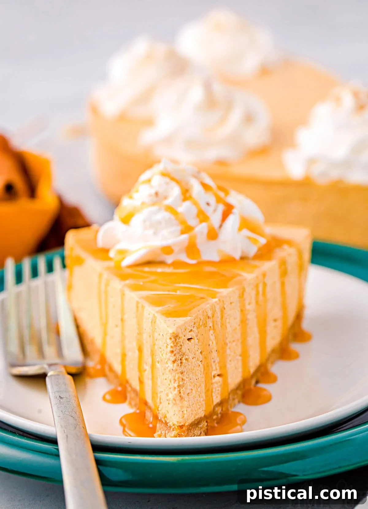 Decadent No Bake Pumpkin Cheesecake 2 A delectable slice of no bake pumpkin cheesecake garnished with fluffy whipped cream and a luscious caramel drizzle, presented on white and green plates.