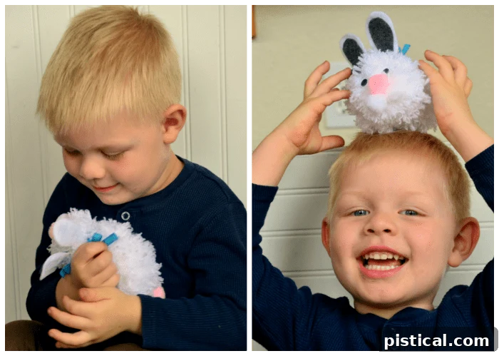 Bryce happily playing with his handmade white pom pom Easter bunny