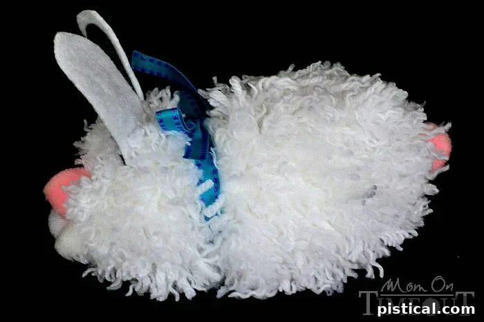 Side View of Pom Pom Bunny Showing Placement of Fluffy Tail and Decorative Ribbon