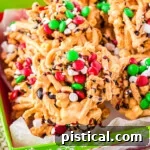 haystacks topped with candy and marshmallows sitting in a red and green Christmas box.