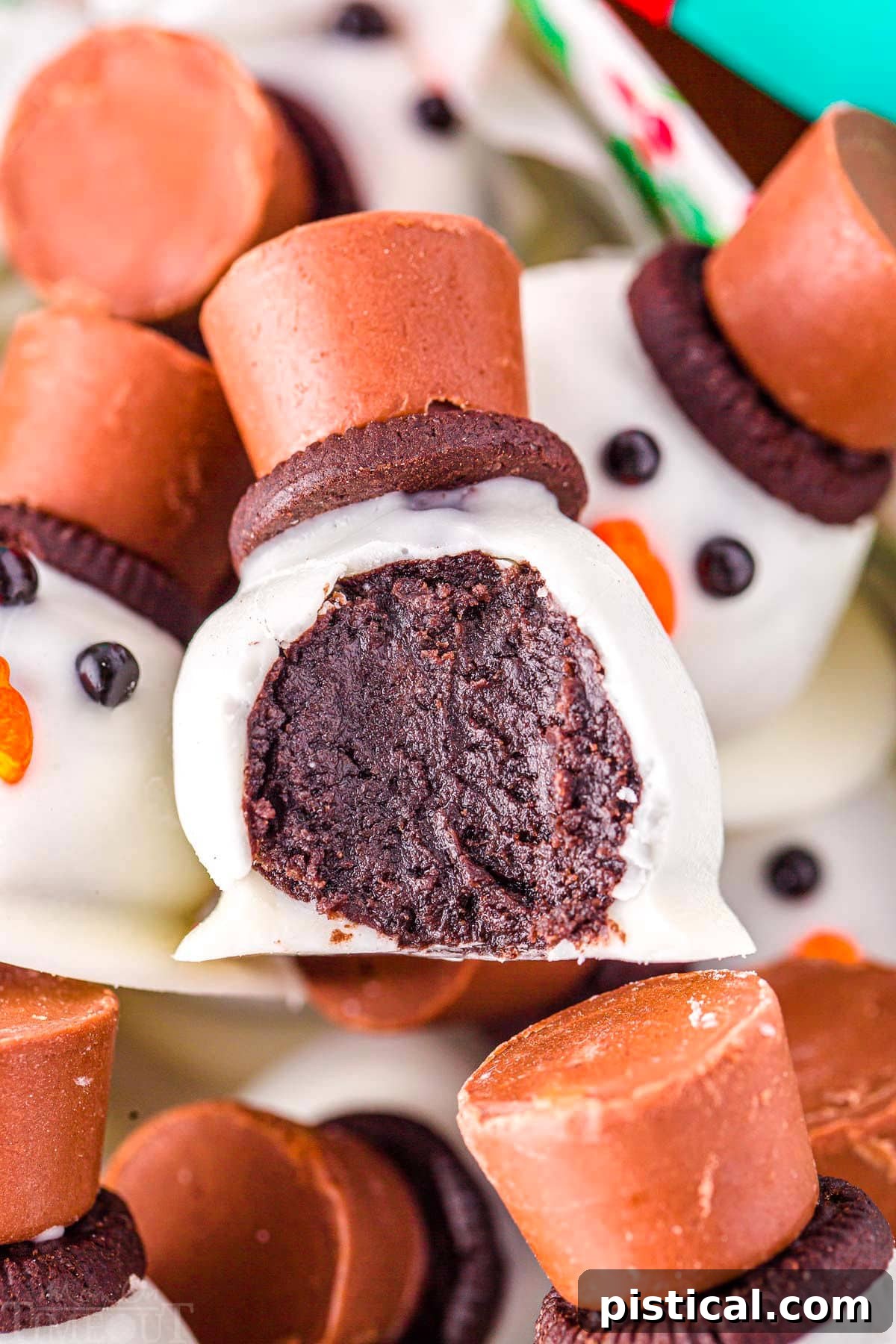 Melting Snowman Oreo Truffles 3 snowman oreo ball with a bite taken out of it in a box with more melting snowman.