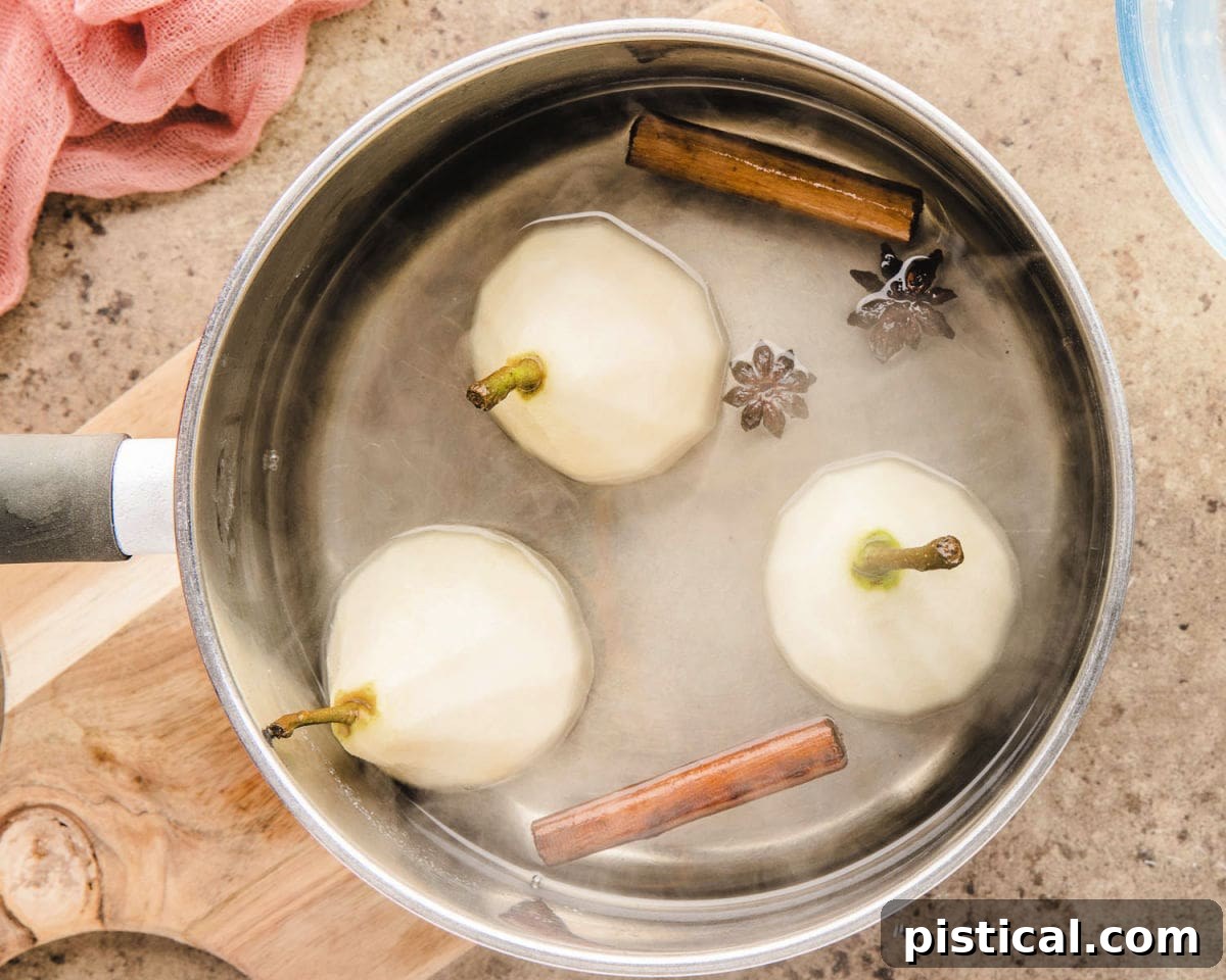 Velvet Pear Indulgence 4 top down shot of three pears being poached in a saucepan.