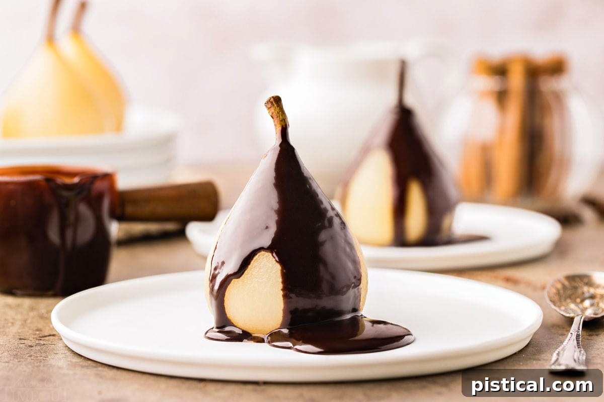 Velvet Pear Indulgence 8 poached pear on a white plate topped with a creamy chocolate sauce.