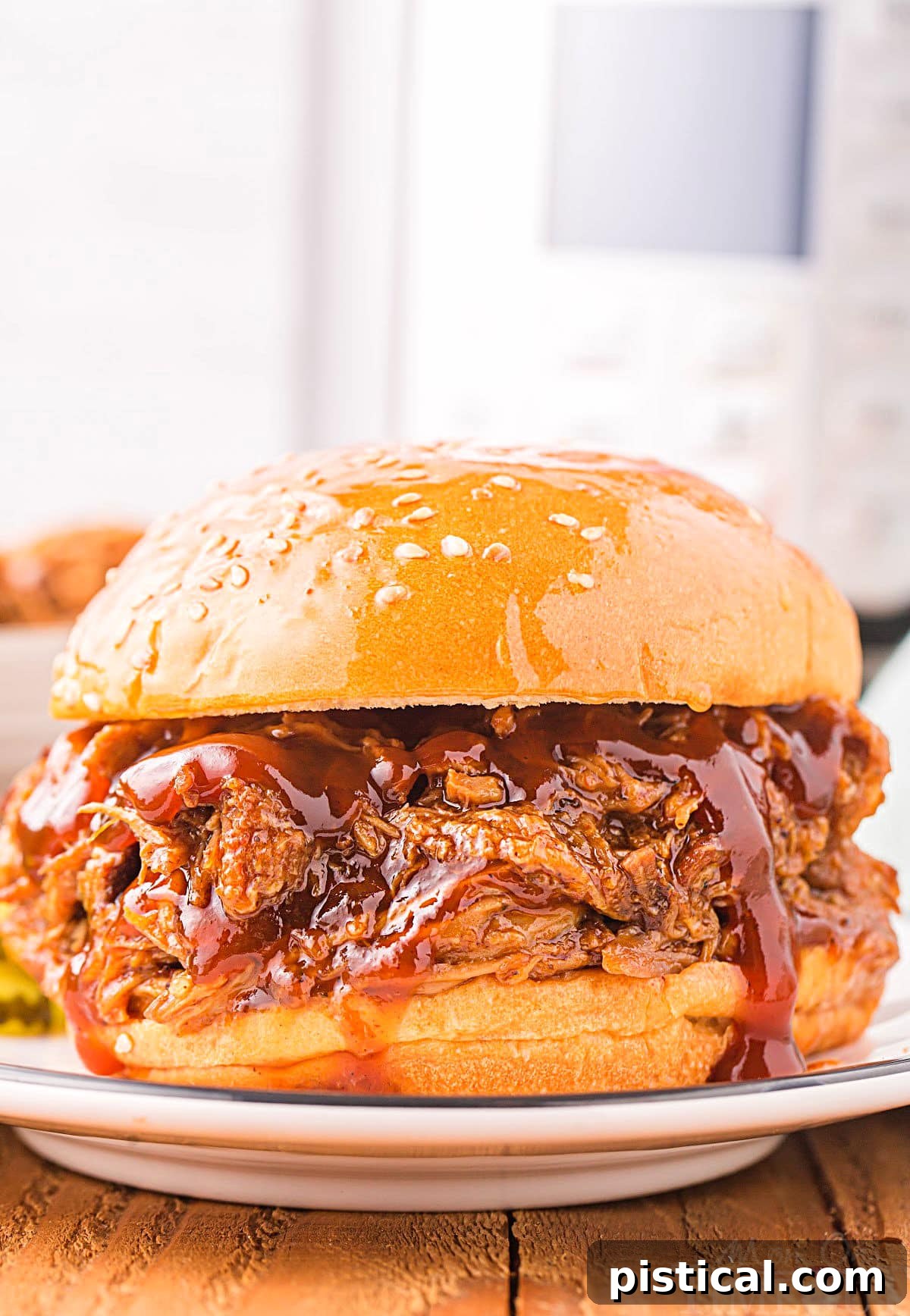 A delicious pulled pork sandwich topped with coleslaw sits on a plate in front of a modern Instant Pot, ready to be enjoyed.
