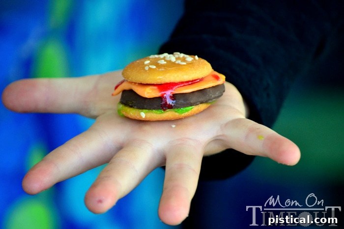 A child happily holding a cookie slider, demonstrating its delightful and kid-friendly size