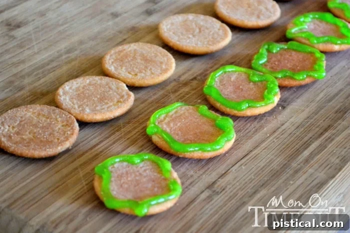 Ingredients for Cookie Sliders: Nilla Wafers, green frosting, and chocolate cookies displayed