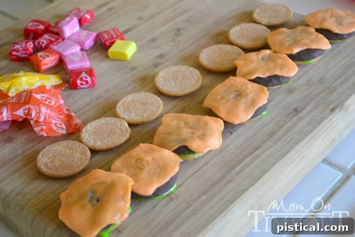 Melted and shaped orange Starburst candy resembling a slice of melted cheese for cookie sliders