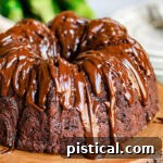 close up look at chocolate zucchini cake with chocolate glaze.