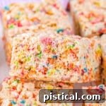 colorful rainbow rice krispie treats cut into squares and ready to enjoy.