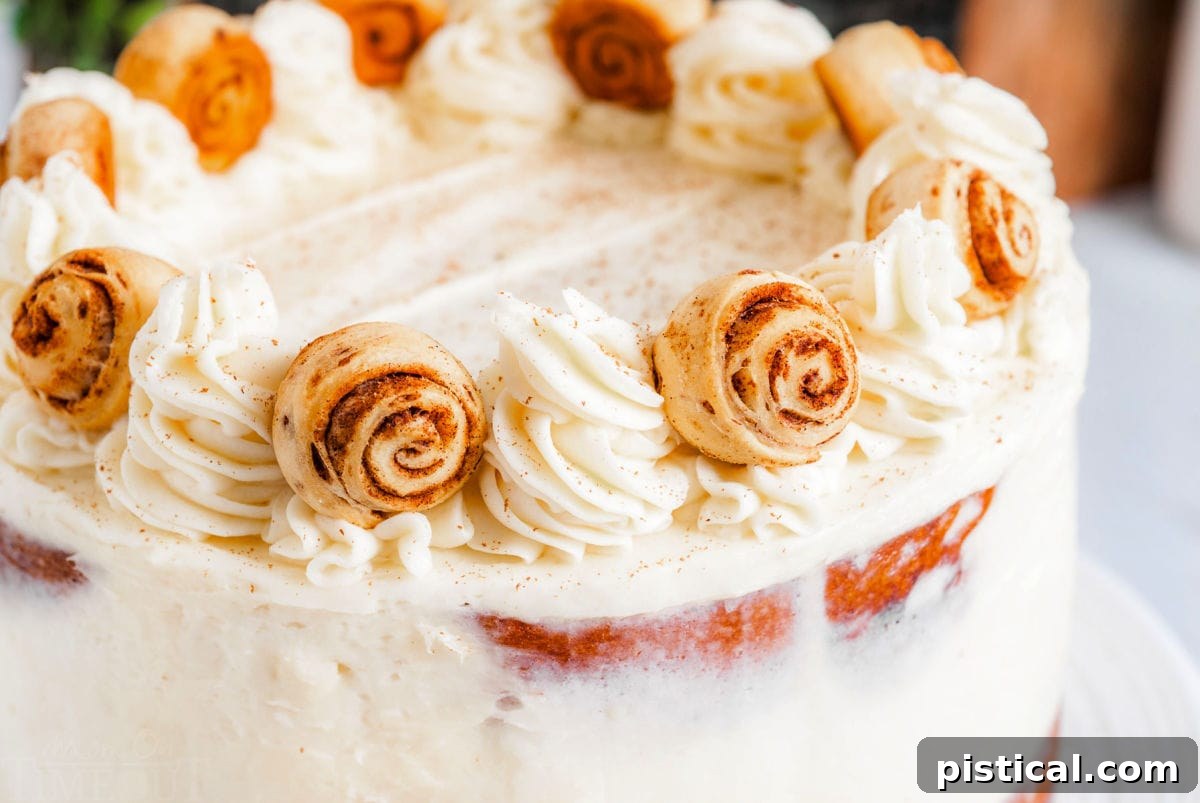 Decadent Cinnamon Swirl Layer Cake 3 A close-up view of the meticulously decorated cinnamon roll cake, showcasing the luscious cream cheese buttercream and the charming miniature cinnamon rolls arranged on top.