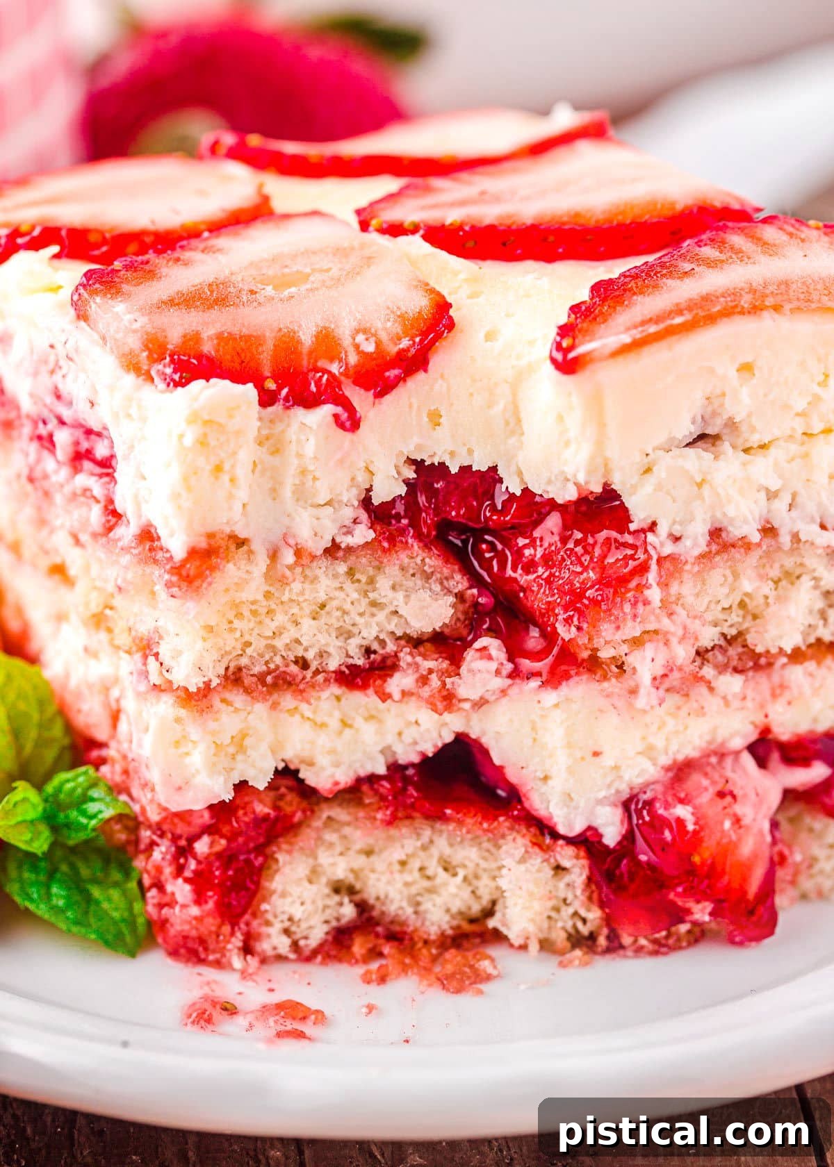 Strawberry Dream Tiramisu 6 A close-up view showing the intricate, creamy layers of Strawberry Tiramisu after a portion has been removed with a fork.