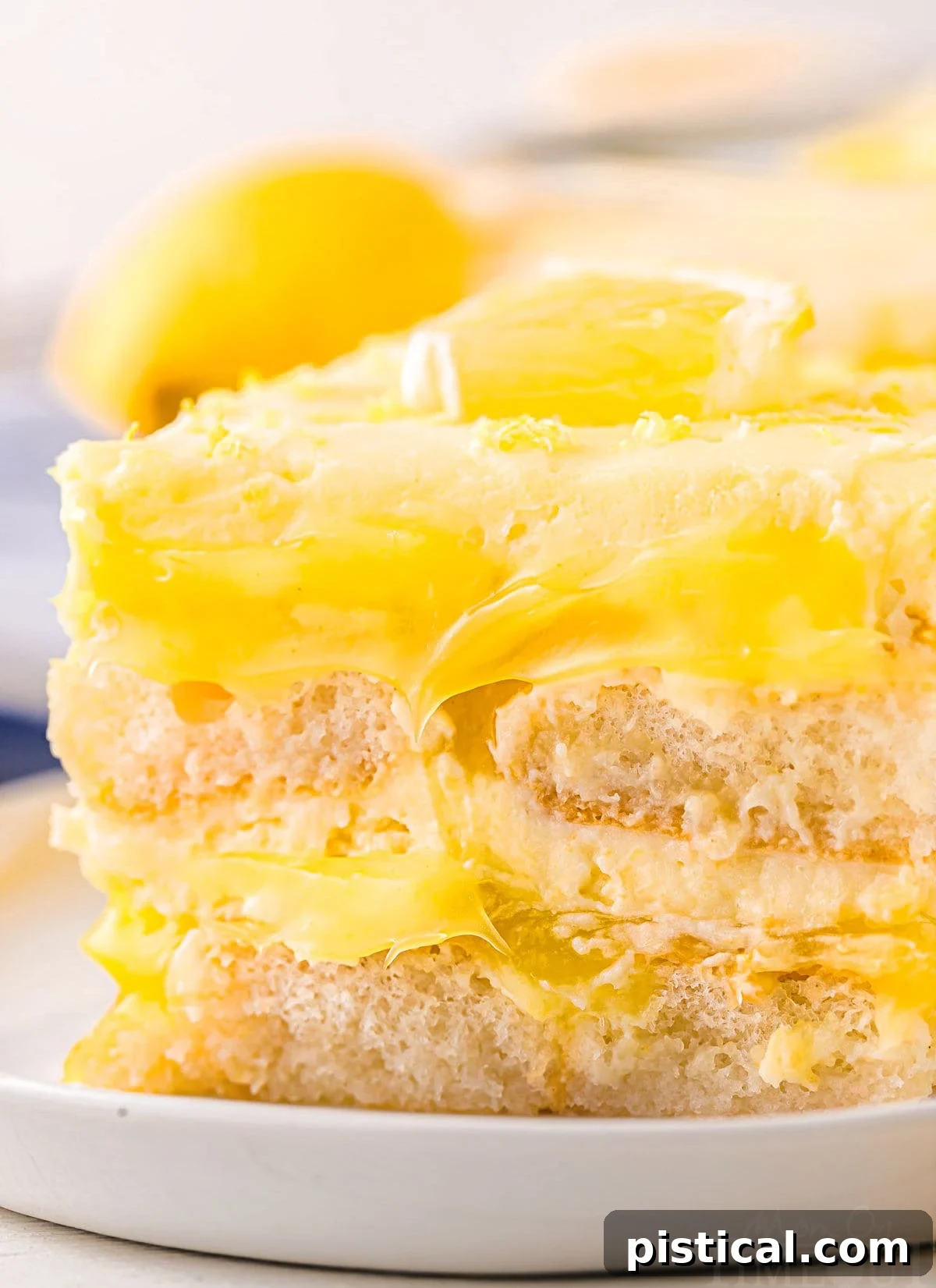 A close-up view highlighting the beautifully distinct layers within this lemon tiramisu recipe, with the ladyfingers and lemon curd layers clearly visible and inviting.