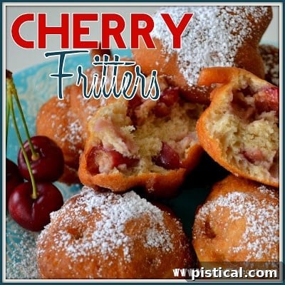 Platter of golden-brown fresh cherry fritters, dusted with powdered sugar, ready to be served.