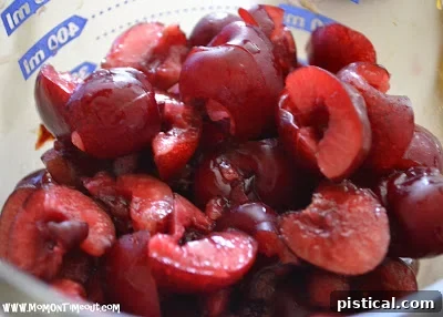 Freshly chopped cherries being gently folded into the light, airy fritter batter.