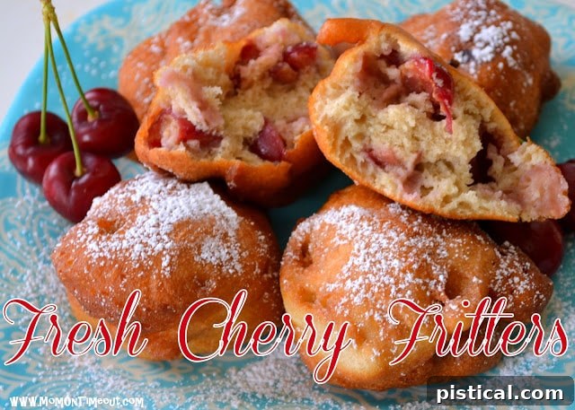 A generous serving of fresh cherry fritters on a plate, with a fork, ready to be enjoyed.