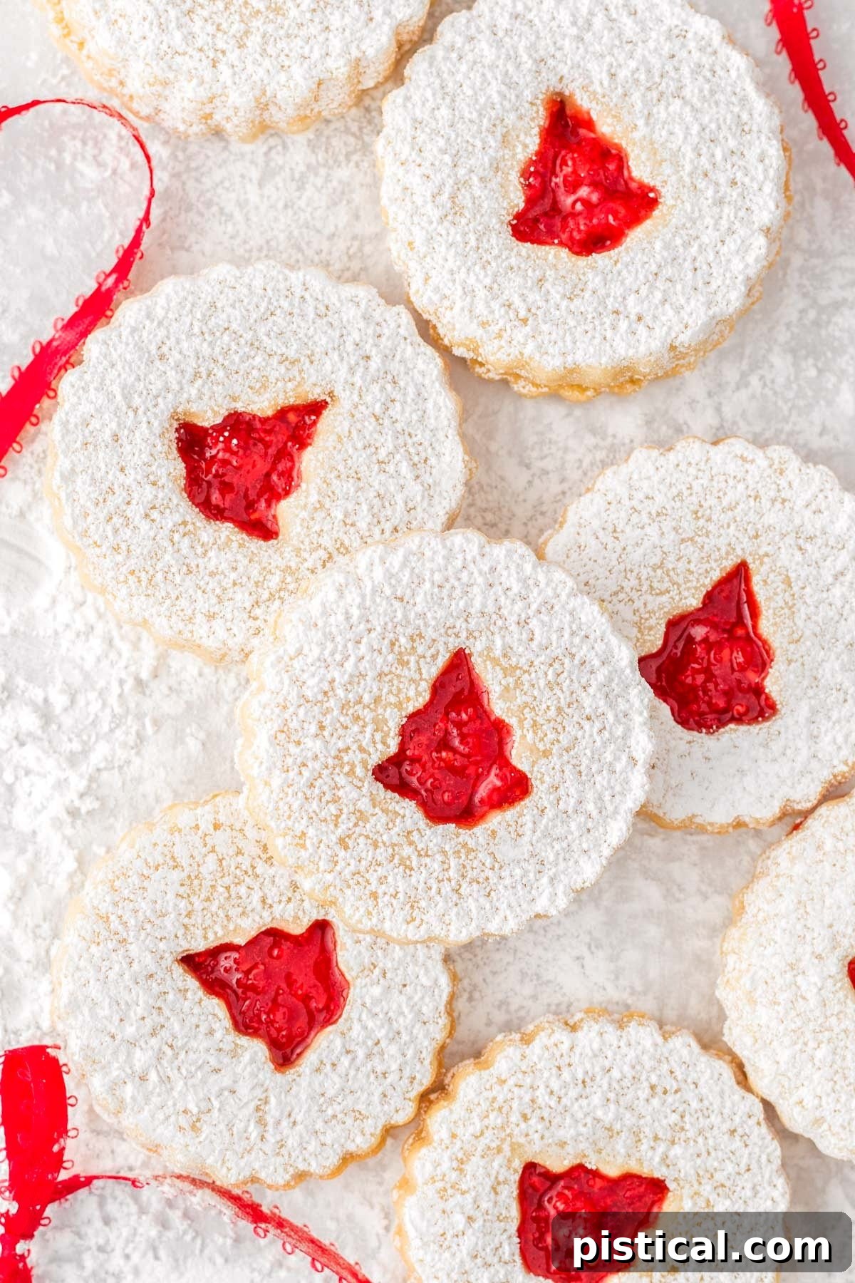 Classic Linzer Cookie Delights 3 top down look at linzer cookies dusted with powdered sugar and a raspberry jam filling.