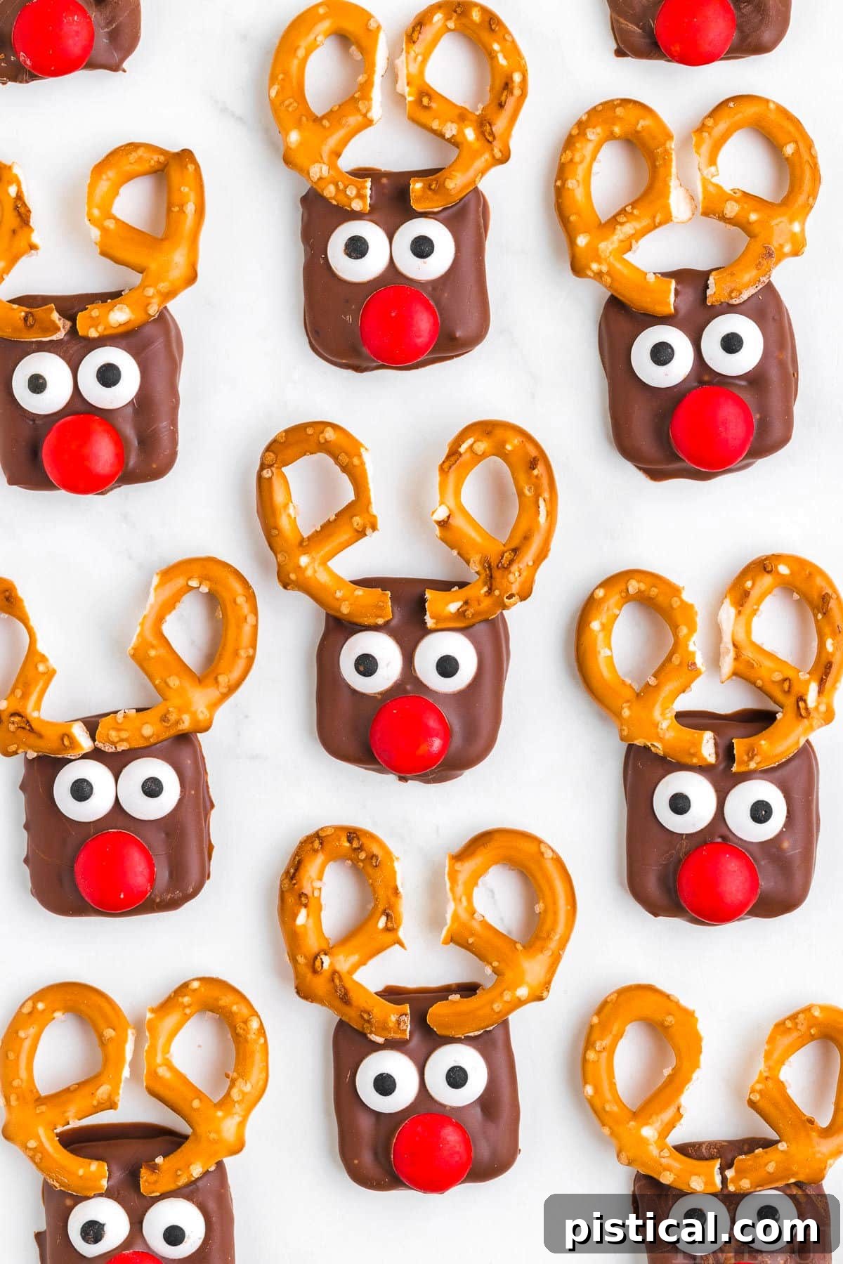 top down look at pretzel reindeer setting up on parchment lined baking sheet.