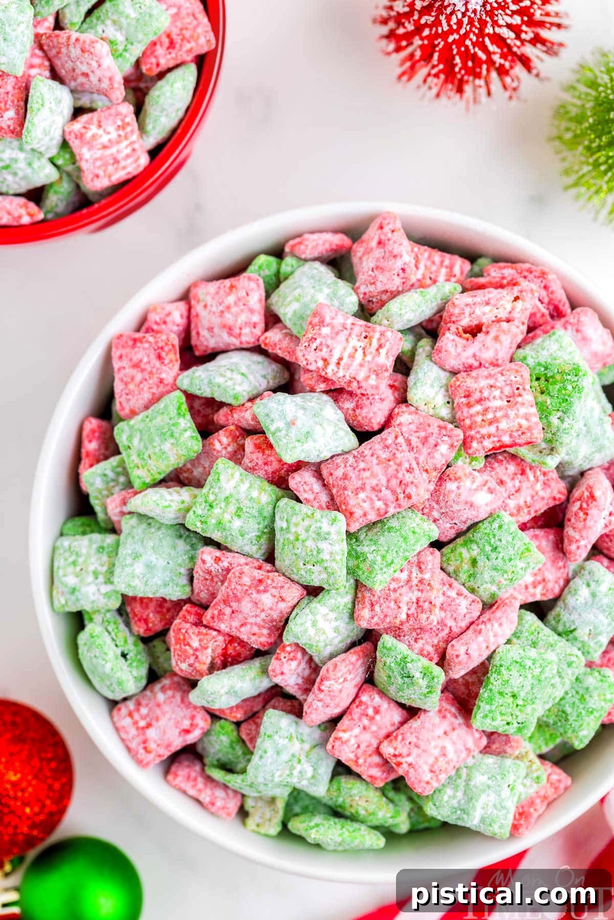 top down view of large white bowl filled with christmas muddy buddies made with red and green melts.