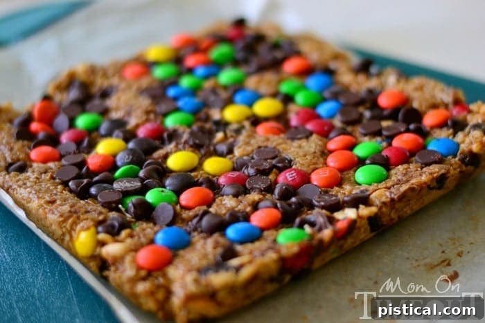 Close-up of no-bake Monster Trail Mix Granola Bars featuring M&Ms and chocolate chips