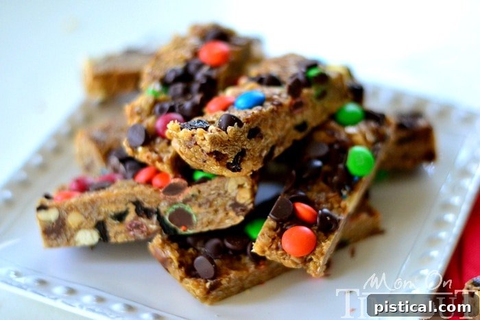 Freshly made no-bake Monster Trail Mix Granola Bars being pressed into a pan