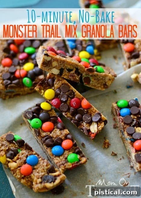A stack of freshly made Monster Trail Mix Granola Bars with a bite taken out of one