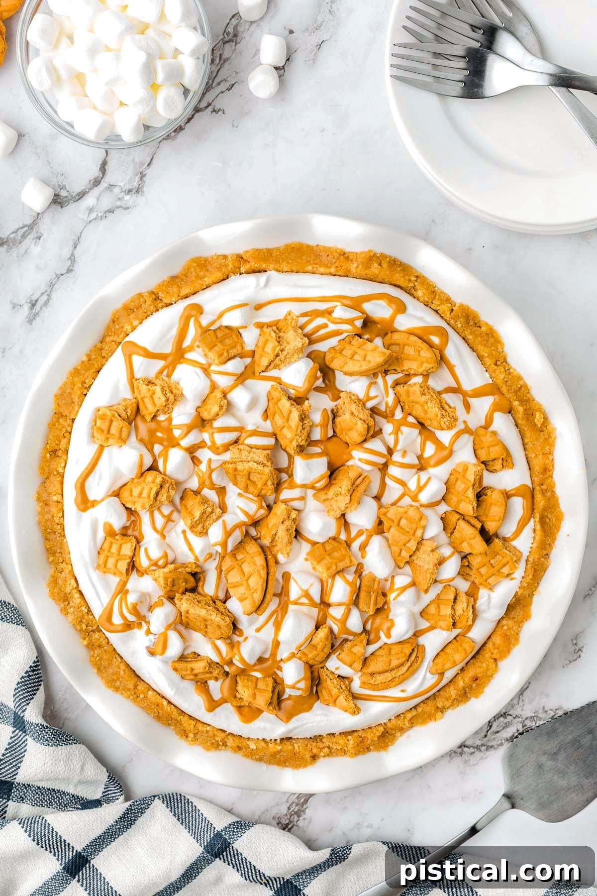 Top down view of a whole Fluffernutter Pie in a white pie dish, showcasing its perfect round shape and inviting toppings.