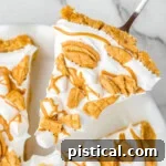 piece of fluffernutter pie being lifted out of the white pie dish.