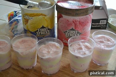 Layered strawberry and vanilla ice cream in clear cups, mimicking Cat in the Hat