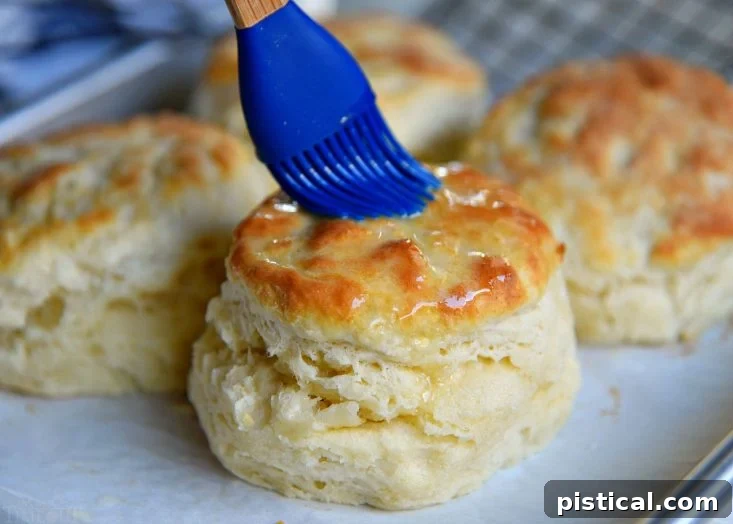 Brushing melted butter on hot biscuits