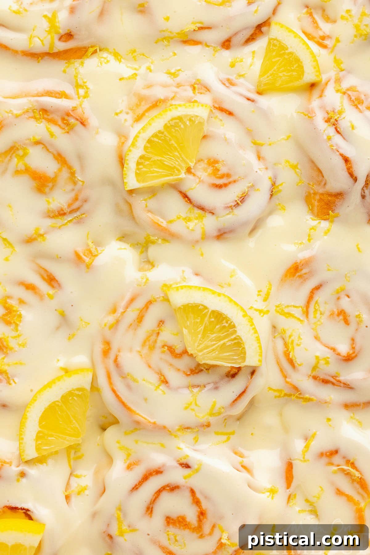 Zesty Lemon Swirls 8 A top-down view of perfectly arranged lemon rolls in a baking pan, ready for serving.