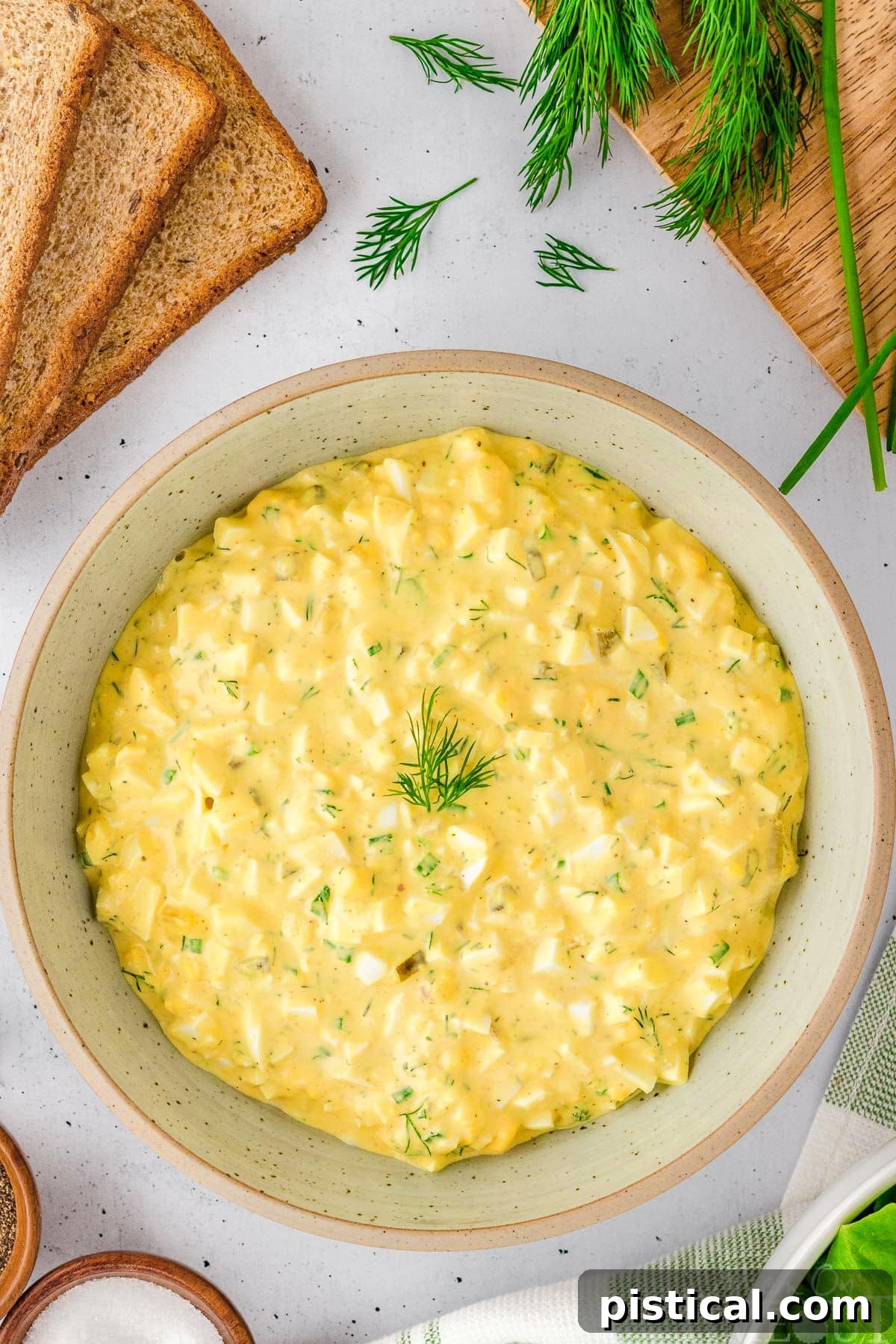 A white bowl of egg salad.