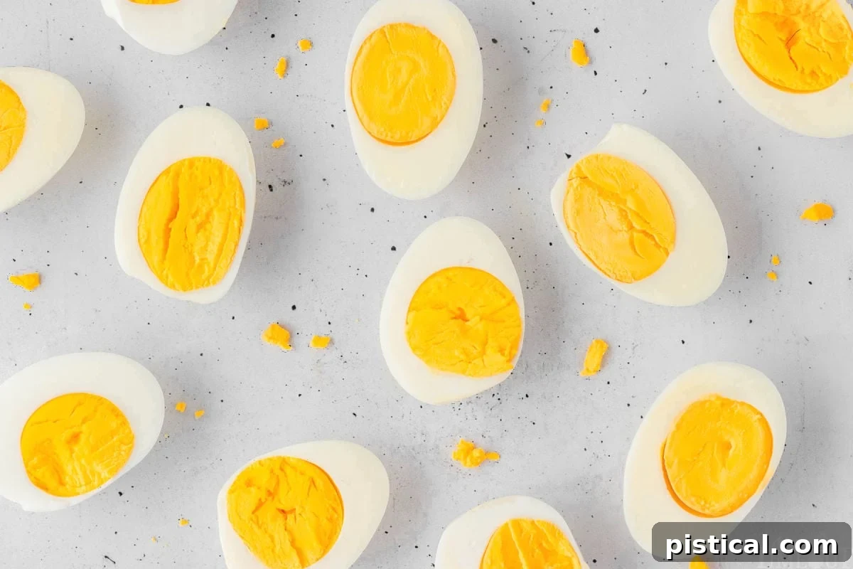 Several perfectly peeled hard-boiled eggs resting on a simple light surface, ready for use.