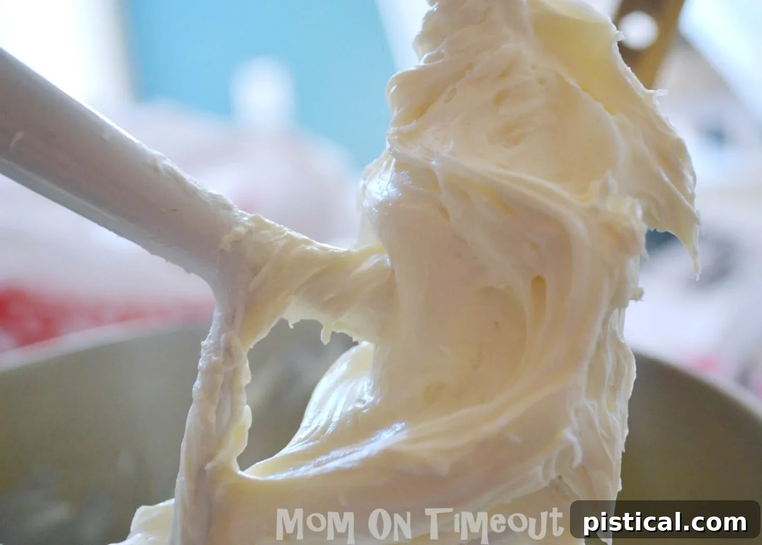 Creamy cheesecake filling being mixed in a bowl.