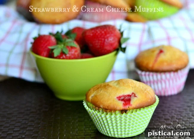 A close-up of the beautiful, thick strawberry muffin batter, rich with cream cheese and fresh strawberry pieces, ready for baking. #muffinbatter #strawberrybaking #homemademuffins